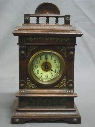 A 19th Century Continental musical clock, the 2" circular dial with Arabic numerals contained in an oak case