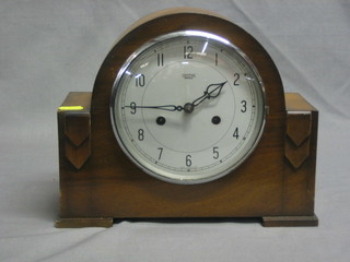 A Smiths 1930's mantel clock contained in an arch shaped walnut case
