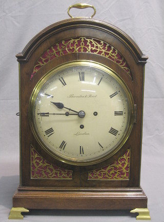 A George III 8 day striking triple fusee bracket clock, the 9" dial with Roman numerals by T H Waites & Reed London, striking on a grand sonnier of 9 bells with plain pendulum, contained in an arched mahogany case with brass carrying handle, grilled panels to the front and sides and 6 1/2" plain back plate, raised on brass bracket feet,