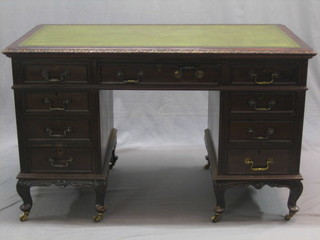 A Chippendale style kneehole pedestal desk with inset tooled leather writing surface above 8 short drawers and 1 long drawer, raised on cabriole supports 50"