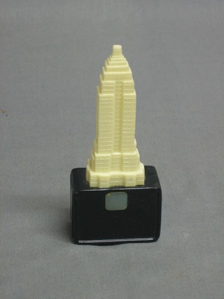A 1930's plastic view finder in the form of the Empire State Building with scenes of New York 4 1/2"