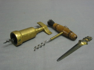 A  brass corkscrew, a wooden and steel corkscrew, a letter opener