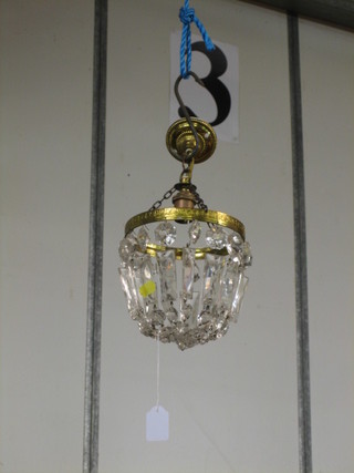 A gilt metal cut glass bag shaped light fitting