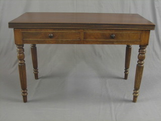 A 19th Century mahogany tea table raised on reeded supports