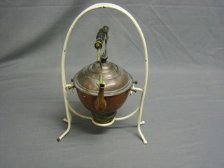 A 19th Century copper tea kettle raised on a white painted iron stand, complete with burner