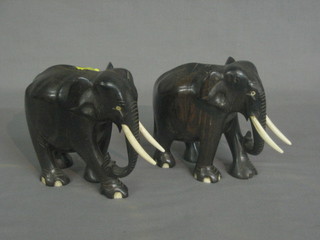 A pair of ebony elephants with ivory tusks 4", (1 with chip to right hand hind quarters)