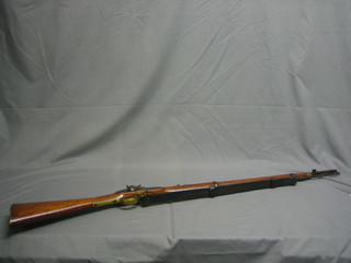 A Victorian Percussion rifle, the 33" barrel with forsight, proof marks, the lock with crowned VR dated 1874, complete with metal ram rod and leather shoulder strap