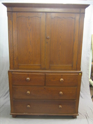 A Victorian oak linen press with moulded cornice, the interior fitted shelves enclosed by panelled doors, the base fitted 2 short and 2 long drawers with tore handles 48"