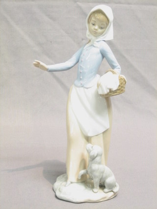 A Nao figure of a standing lady with basket and seated dog 10"