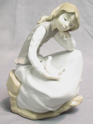 A Nao figure of a crouching girl with dove 9"