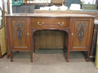 An Edwardian Georgian style mahogany sideboard fitted 2 cupboards enclosed by a carved panelled door and bow front drawer to the centre, raised on square tapering supports ending in spade feet 66"