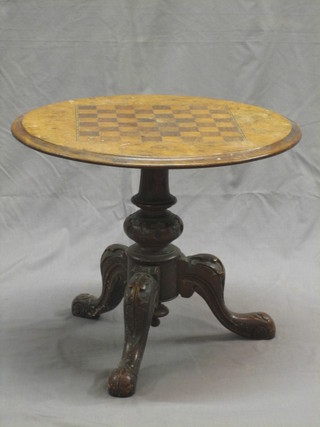 A Victorian circular figured walnut and inlaid chess table, raised on carved tripod and column base, 20"
