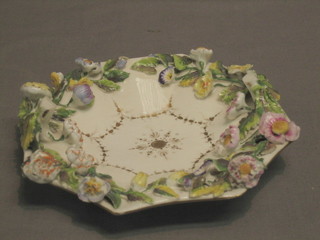 A Rockingham octagonal bowl with floral encrusted decoration (f, missing handle) 