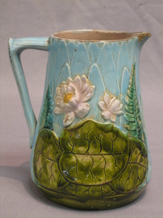A Victorian Majolica jug with floral decoration (slight crack) 7"