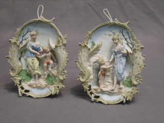 A pair of Victorian biscuit porcelain wall relief plaques depicting figures 7"