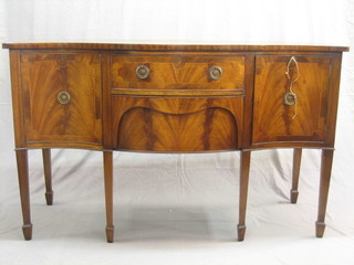 A 20th Century Georgian style sideboard of serpentine outline fitted 2 long drawers flanked by a pair of cupboards, raised on square tapering supports ending in spade feet 60"