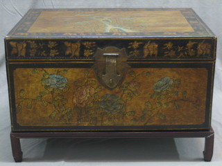 An Eastern lacquered trunk with hinged lid, raised on a hardwood stand 30"