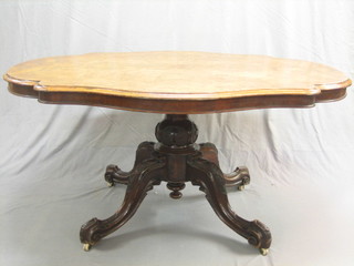 A Victorian oval figured walnut Loo table  raised on a carved tripod base 59"