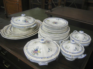 A 36 piece Royal Doulton dinner service comprising oval meat plate 18" (cracked), oval meat plate 16" (cracked), ditto 14" (cracked), 3 ditto 11", 13" and 11" (all cracked), 2 twin handled vegetable tureens and covers (1 cracked), 2 twin handled sauce tureens and covers (1 cracked), 8 dinner plates 10" (4 cracked), 8 side plates 9" (3 cracked), 10 side plates 8" (6 cracked), many crazed throughout, the base with Royal Doulton mark 4389 with floral decoration