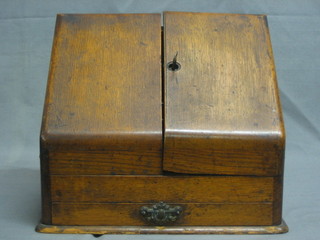 A late Victorian oak stationery box with stepped interior enclosed by panelled doors, having a drawer to the base 12"