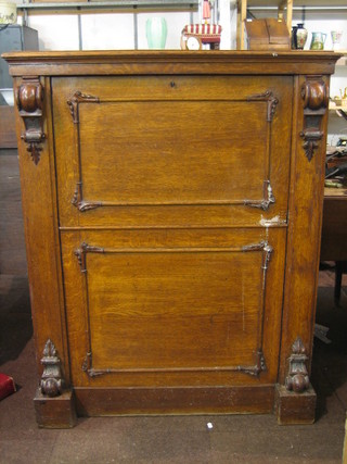 A Victorian Continental oak escritoire with fall front and carved oak cabinet 38"