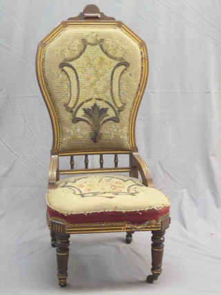 An aesthetic movement walnut nursing chair with upholstered seat and back, raised on turned supports