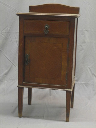 An Edwardian inlaid mahogany bedside cabinet fitted a drawer above a cupboard raised on square tapering supports 16"