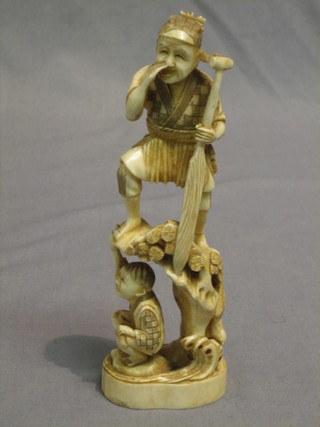 A carved Eastern ivory figure of a standing man with paddle and crouching boy 7"