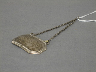 A silver decanter label marked February 11 1915-1936 and a silver walking stick handle