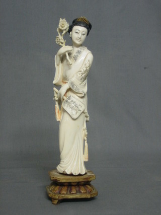 A fine quality carved ivory figure of a standing Geisha girl raised on a hardwood stand 9"
