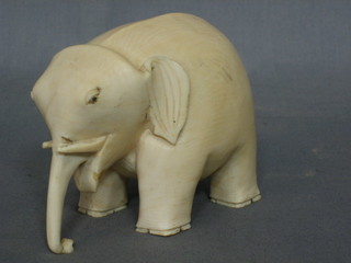 A large carved ivory figure of an elephant 5"