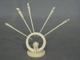 A carved ivory cocktail stick stand with 5 sticks