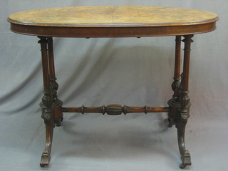 A Victorian oval figured walnut stretcher table, raised on turned supports with H framed stretcher 41" (veneers blistering)