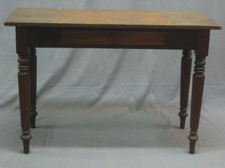 A Victorian rectangular mahogany writing table  fitted a drawer, raised on turned and reeded supports 42"
