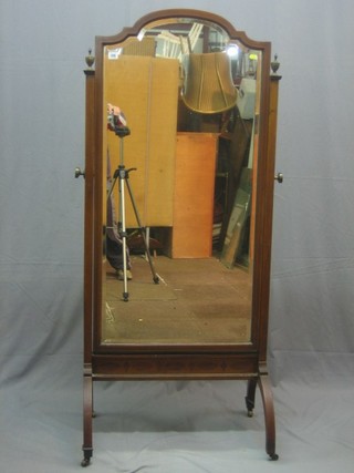 An Edwardian arch shaped plate cheval mirror contained in a mahogany swing frame