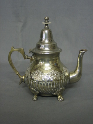 An Eastern silver plated teapot with embossed engraved decoration