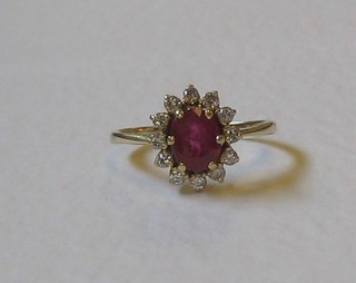 A lady's gold dress ring set rubies surrounded by diamonds