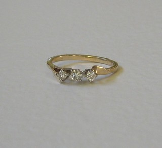 A gold 3 stone ring set diamonds
