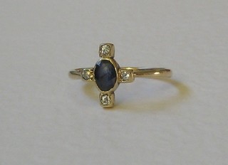 A lady's gold dress ring set an oval cut sapphire supported by 4 diamonds