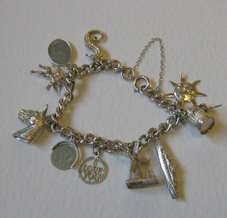 A lady's silver curb link charm bracelet hung 10 various charms
