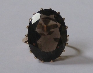 A 9ct gold dress ring set an oval cut smoky quartz