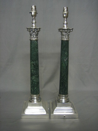 A pair of "malachite" and silver plated table lamps with stepped bases and Corinthian column capitals