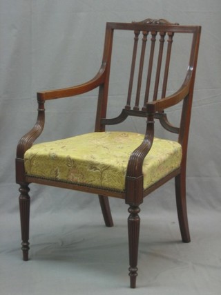 A 19th Century Georgian style stick and bar back open arm desk chair, raised on turned and reeded supports
