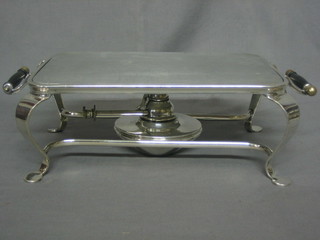A rectangular silver plated twin handled hot plate complete with burner, raised on cabriole supports 11"