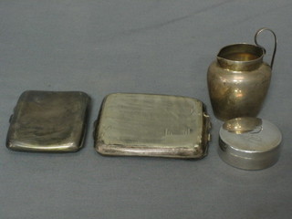 A silver cigarette case, 1 other cigarette case (f), a small silver cream jug and a Continental silver cylindrical pill box (4)
