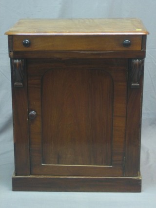 A Victorian mahogany enclosed washstand with hinged lid, the base fitted a cupboard enclosed by an arch shaped panelled door raised on a platform base 26"