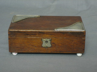 An Edwardian oak cigarette box with hinged lid and silver mounts Birmingham 1904, 6 1/2"