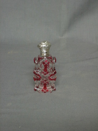 A Victorian red overlay cut glass scent bottle with embossed silver lid 3 1/2"