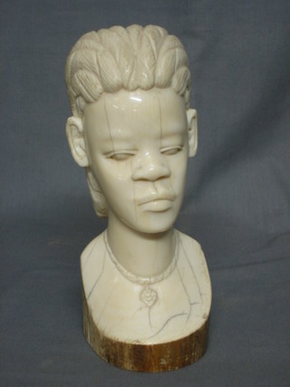 A carved ivory head and shoulders portrait bust of a native 9"