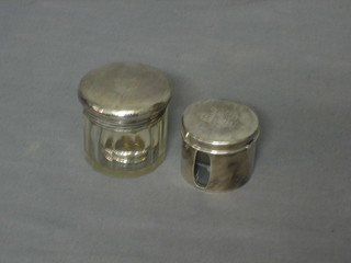 A cylindrical travelling Sterling silver 2 bottle salt holder and a cut glass dressing table jar with silver lid and 1 other silver lid